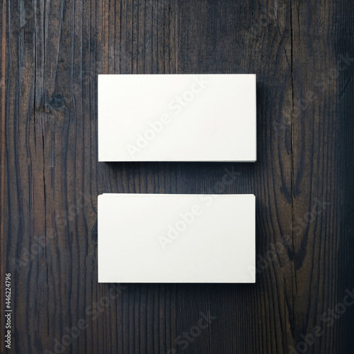 Mockup of blank business cards on wood table background. Top view. Flat lay.