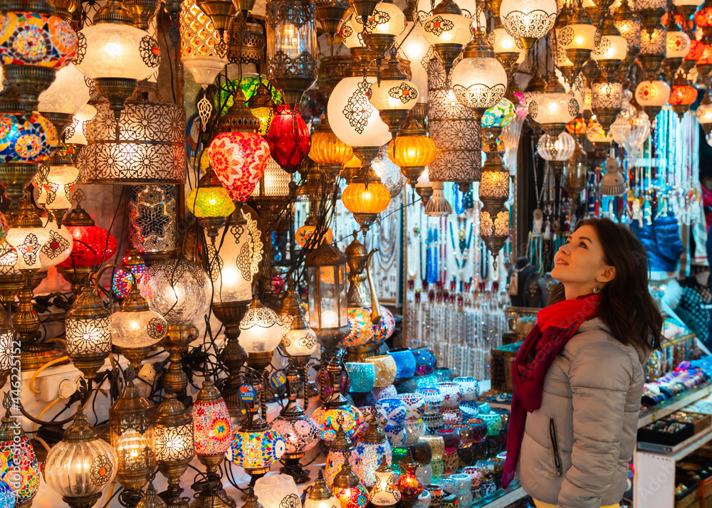 Young woman looking at lamps in the store