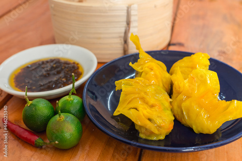Steamed Shark fin dumplings served with chili garlic oil and calamansi. photo