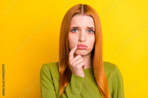 Photo of sad red hair young lady finger chin wear green sweater isolated on yellow color background