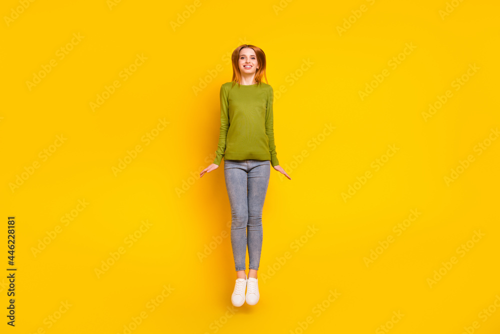 Full length body size photo jumping up smiling happy isolated vibrant yellow color background Full length body size photo jumping up smiling happy isolated vibrant yellow color background