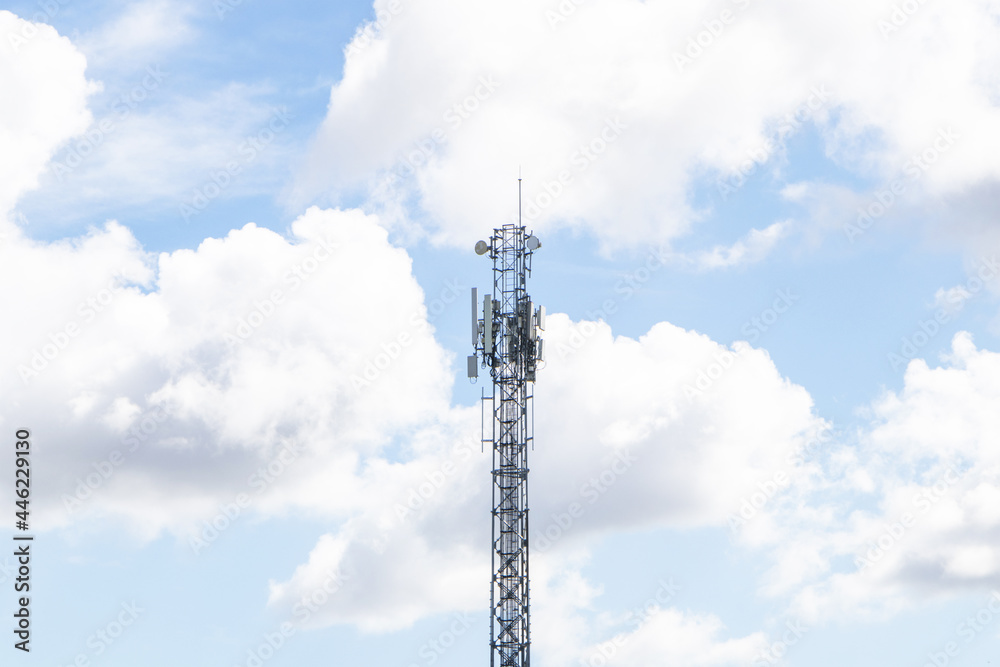 Telecommunication tower with antennas isolated on sky cloud background. Wireless Communication Antenna Transmitter. Telecommunication tower 4G and 5G cellular Base Station Base Transceiver Station. Telecommunication tower with antennas isolated on sky cloud background. Wireless Communication Antenna Transmitter. Telecommunication tower 4G and 5G cellular Base Station Base Transceiver Station.