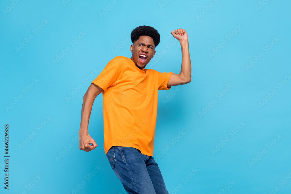 Portrait of attractive cheerful lucky guy celebrating having fun great success isolated over bright blue color background Portrait of attractive cheerful lucky guy celebrating having fun great success isolated over bright blue color background