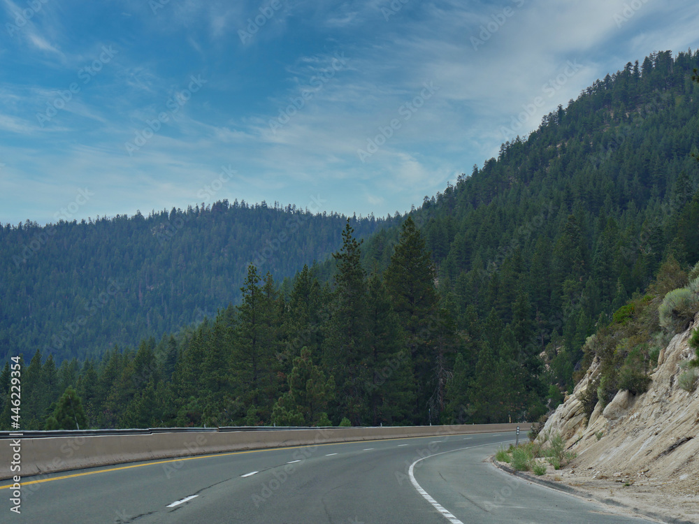 Winding road with distant mountains and forests in Nevada.