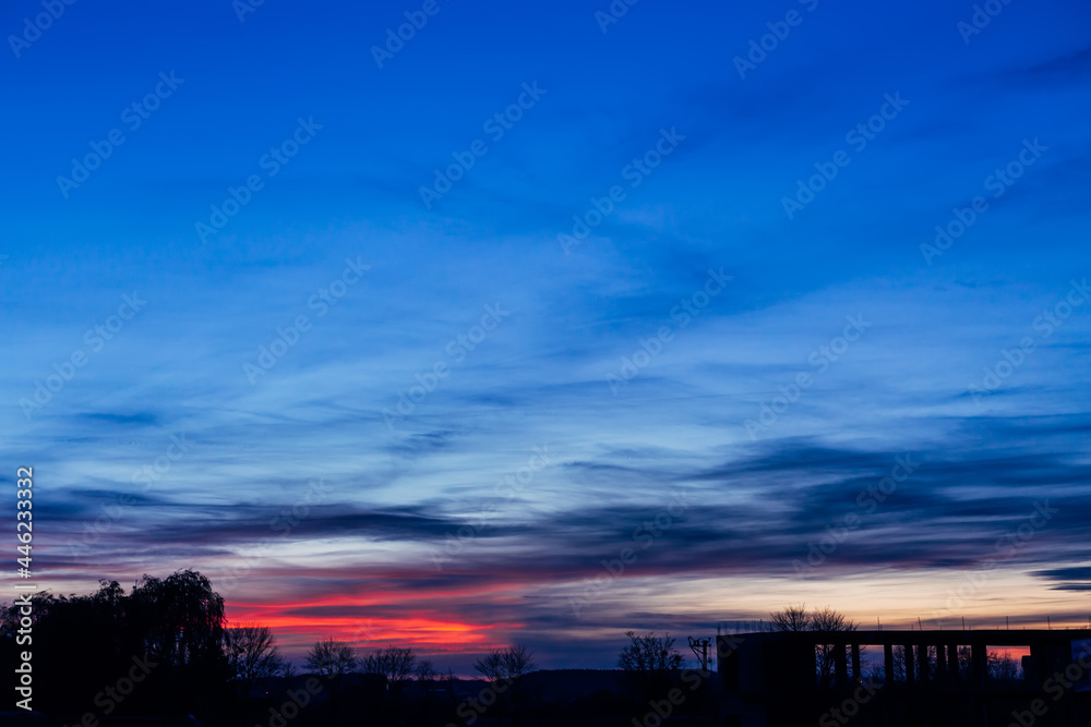 Naklejka premium Dramatic sunset and sunrise sky. Purple and blue clouds