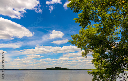 Panoramic summer view of Jezioro Selmet Wielki lake landscape with wooded island in Sedki village in Masuria region of Poland photo