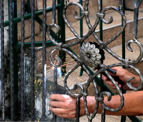 Welder at work, welding metal gate