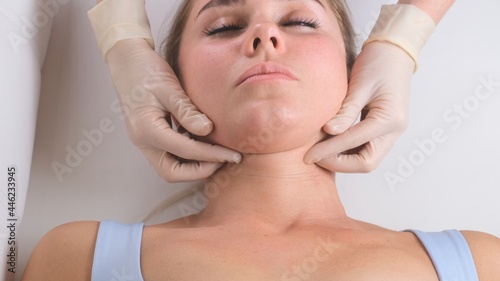 Chin massage of woman young woman during face massage at beauty salon