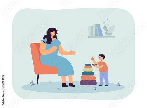 Mother sitting on chair, helping her son assemble pyramid. Mom and kid playing and spending time together flat vector illustration. Parenthood concept for banner, website design or landing web page