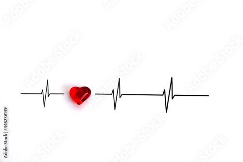 Light-reflecting, red heart of glass with curves of cardiac cycles or heartbeats in an electrocardiogram (ECG) against white background