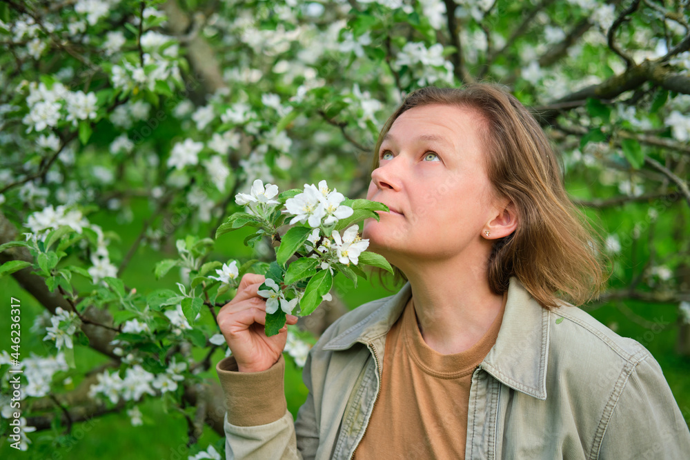 Adult woman in the spring park near the spring apple trees, portrait Adult woman in the spring park near the spring apple trees, portrait