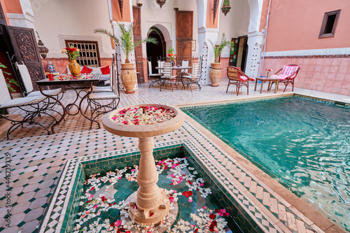 Traveling by Morocco. Relaxing in festive moroccan traditional riad in medina. photo