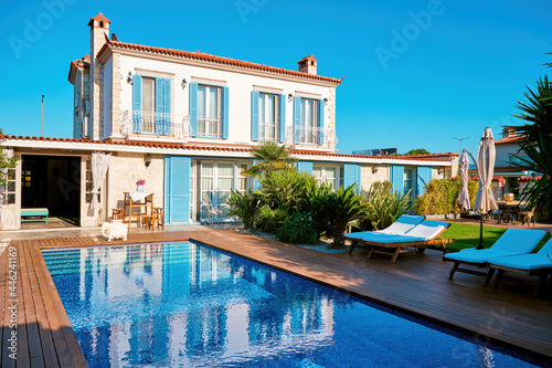 Aegean or Mediterranean type luxury stone villa exterior with pool © Cagkan