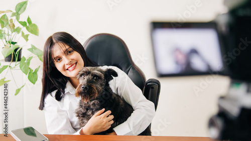 infuencer streaming from his office or home showing his dog