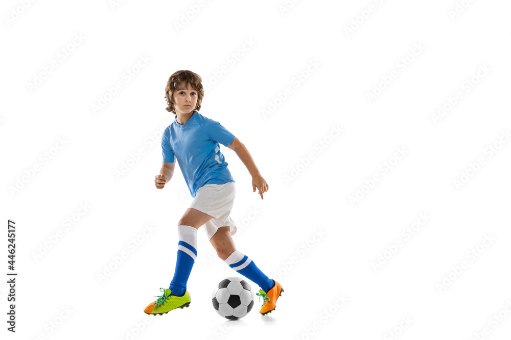 Obraz premium Young sportsman, football soccer player, child playing football isolated on white studio background. Concept of sport, game, hobby