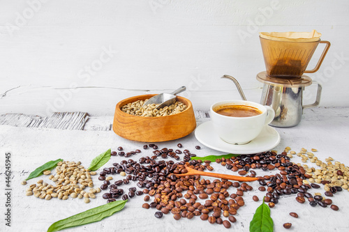 Equipment used to brew coffee drift and coffee beans with a cup of coffee photo