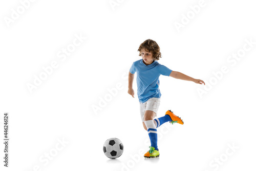 Young sportsman, football soccer player, child playing football isolated on white studio background. Concept of sport, game, hobby © master1305