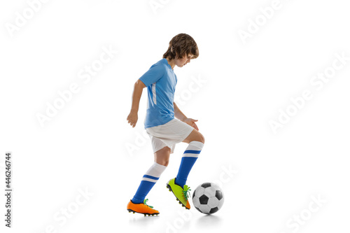 One preschool boy, football soccer player in action, motion training isolated on white studio background. Concept of sport, game, hobby © master1305