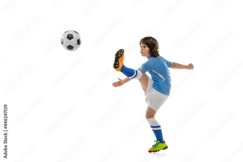 Young sportsman, football soccer player, child playing football isolated on white studio background. Concept of sport, game, hobby