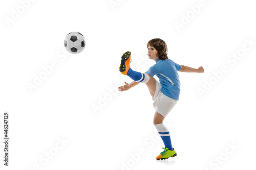 Young sportsman, football soccer player, child playing football isolated on white studio background. Concept of sport, game, hobby