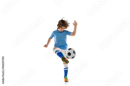 Young male football soccer player, boy training with football ball isolated on white studio background. Concept of sport, game, hobby © master1305