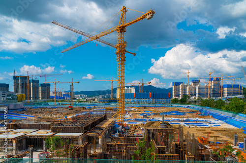 Tower Crane and building modern under construction against blue sky at south korea