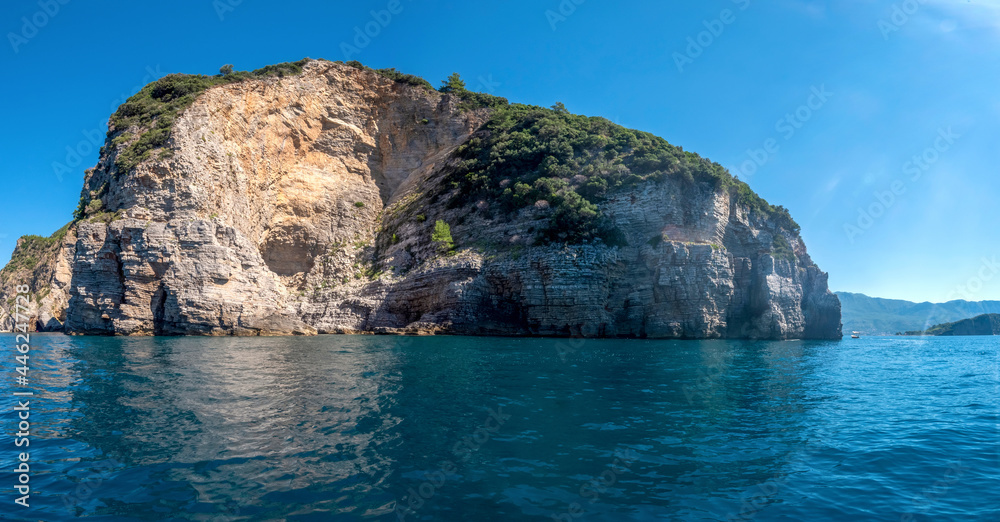 Picturesque view of the cliffs from the sea. Budva riviera, Montenegro Picturesque view of the cliffs from the sea. Budva riviera, Montenegro