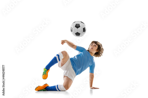 Portrait of little male football soccer player  boy training with football ball isolated on white studio background. Concept of sport  game  hobby
