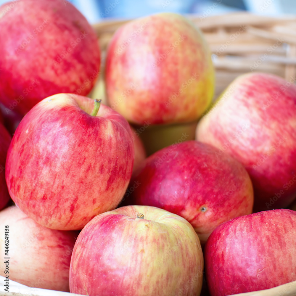 Red ripe apples in a wicker basket. Selective focus Red ripe apples in a wicker basket. Selective focus