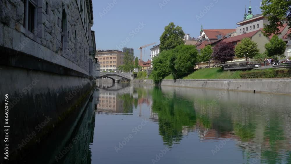 Low angle view of Ljubljanica river and famous Triple Bridge in Ljubljana city, Slovenia. Beautiful vintage architecture. Static shot, real time Low angle view of Ljubljanica river and famous Triple Bridge in Ljubljana city, Slovenia. Beautiful vintage architecture. Static shot, real time