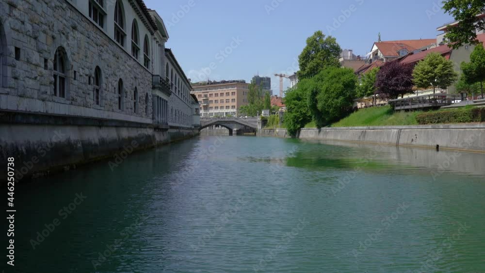 Low angle view of Ljubljanica river and famous Triple Bridge in Ljubljana city, Slovenia. Beautiful vintage architecture. Static shot, real time Low angle view of Ljubljanica river and famous Triple Bridge in Ljubljana city, Slovenia. Beautiful vintage architecture. Static shot, real time