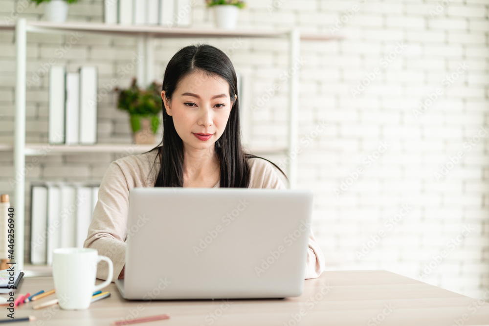 Beautiful young Asian woman wear surgical mask working from home and feeling happy smiling with joyful expression Beautiful young Asian woman wear surgical mask working from home and feeling happy smiling with joyful expression