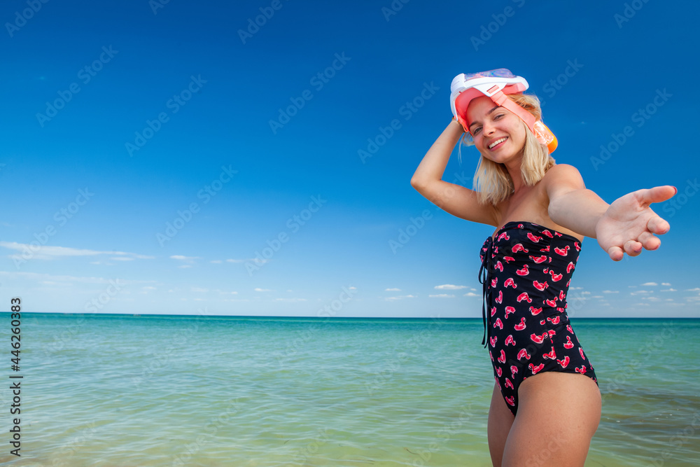 young blonde woman in a swimsuit and a mask for scuba diving close-up on the background of the sea young blonde woman in a swimsuit and a mask for scuba diving close-up on the background of the sea