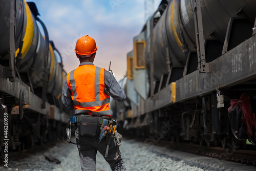 back view service worker with freight train oil transport on background. photo