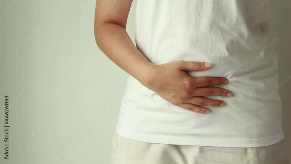 Young woman suffering from abdominal pain.Chronic gastritis or abdomen bloating and healthcare concept. Young woman suffering from abdominal pain.Chronic gastritis or abdomen bloating and healthcare concept.