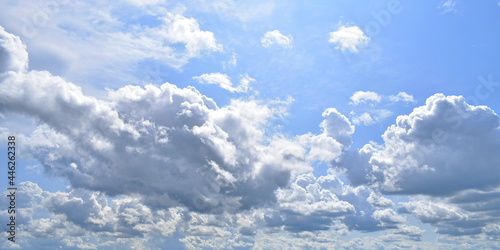 White clouds in the blue sky on a sunny day. Background with large clouds close-up. © Lukeriya