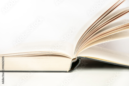 Open hardcover book on white background. Educational concept
