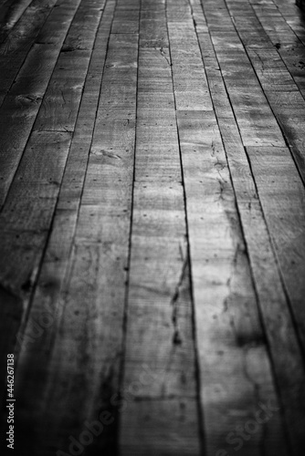 Black and white image of an old wood floor, shot with shallow depth of field.