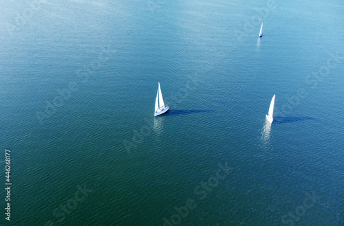 Aerial view of white yachts with sail. Ships in the blue sea