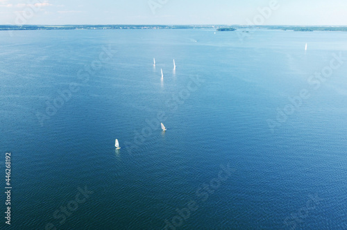 Aerial view of white yachts with sail. Ships in the blue sea © Payllik