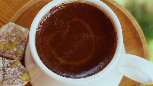 Strong coffee and Turkish delight with traditional cup top view.4K Macro