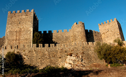 Walls of the medieval castle in Montemor-o-Velho, enlightened by yellow-light-sunset