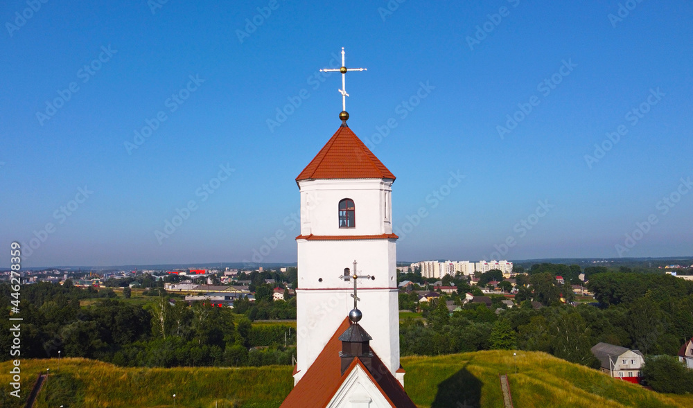 Aerial view of the cross on the tower. Medieval European church with Romanesque architecture
