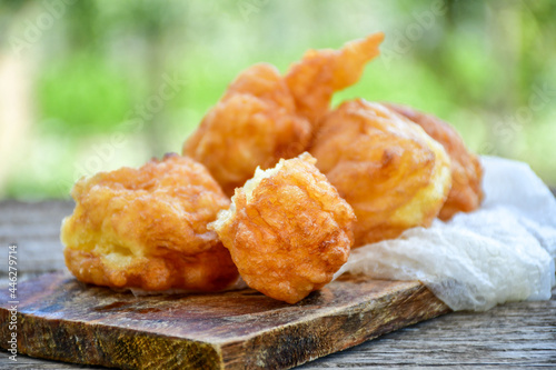 Traditional Bulgarian home made deep fried  patties  covered with sugar  оn rustic backgroud.Mekitsa or Mekica,  on wooden  rustic  background. Made of kneaded dough that is deep fried  photo