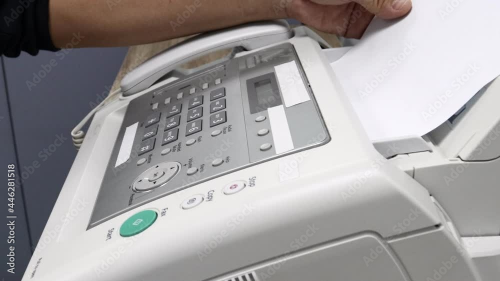 hand man is using a fax machine in the office, equipment for data transmission. hand man is using a fax machine in the office, equipment for data transmission.
