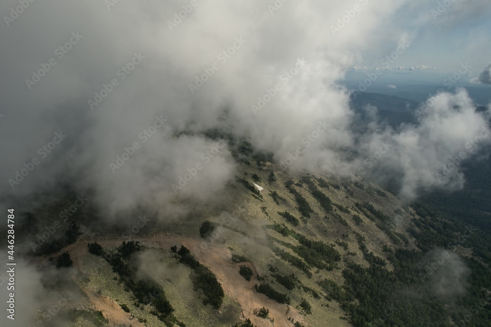 Obraz premium a volcano in clouds and white steam in the early morning. epic and mystical view of the mountain with thick fog around the old volcano