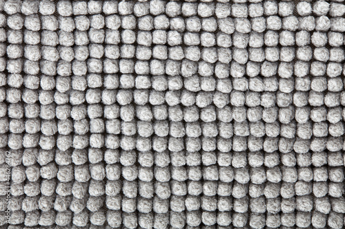 Gray, soft bath mat texture background in natural cotton