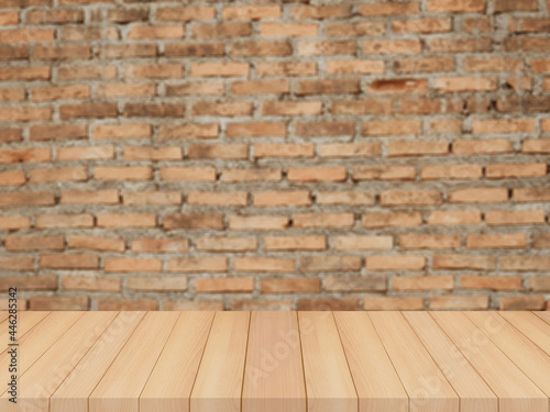 wood table with blurred brick wall background for product display © amonphan