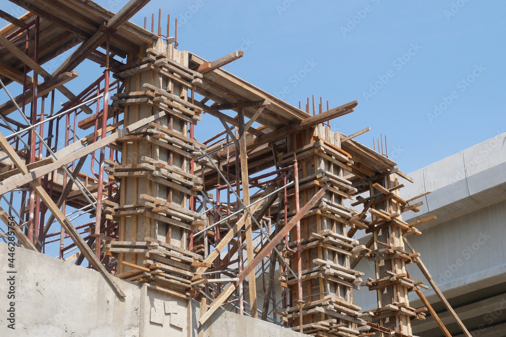 PENANG, MALAYSIA -JUNE 3, 2021: Column timber formwork and reinforcement bar at the construction site. Installed by construction workers. The formwork supported by the temporary wood support.