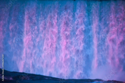 Niagara Falls at night under colored lights